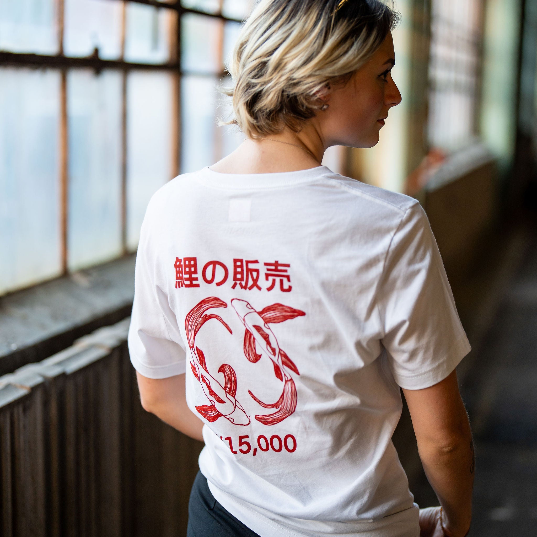 woman wearing white streetwear shirt with red koi fish design